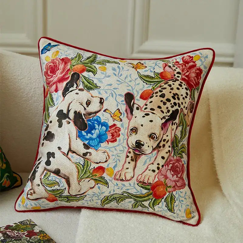 Decorative pillow with dalmatian dogs and flowers on a beige sofa.
