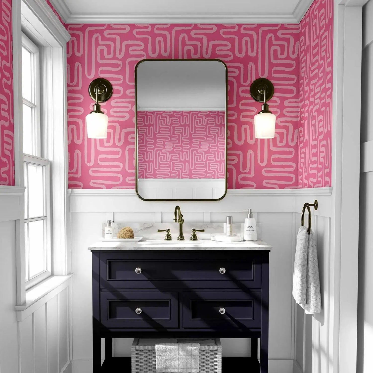 Bathroom with pink geometric wallpaper, black vanity, and white fixtures.