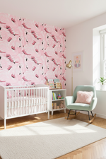 Nursery room with pink flamingo wallpaper, white crib, and rocking chair.