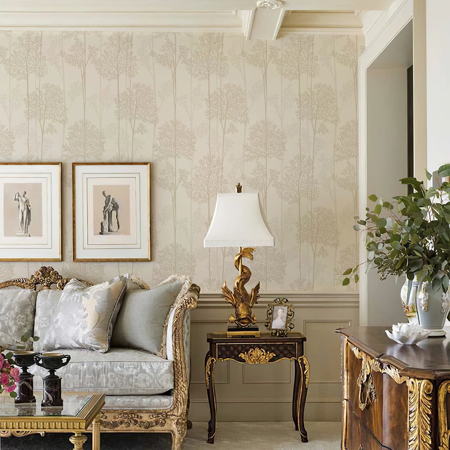 Luxurious living room with ornate furniture, decorative lamp, and framed art.