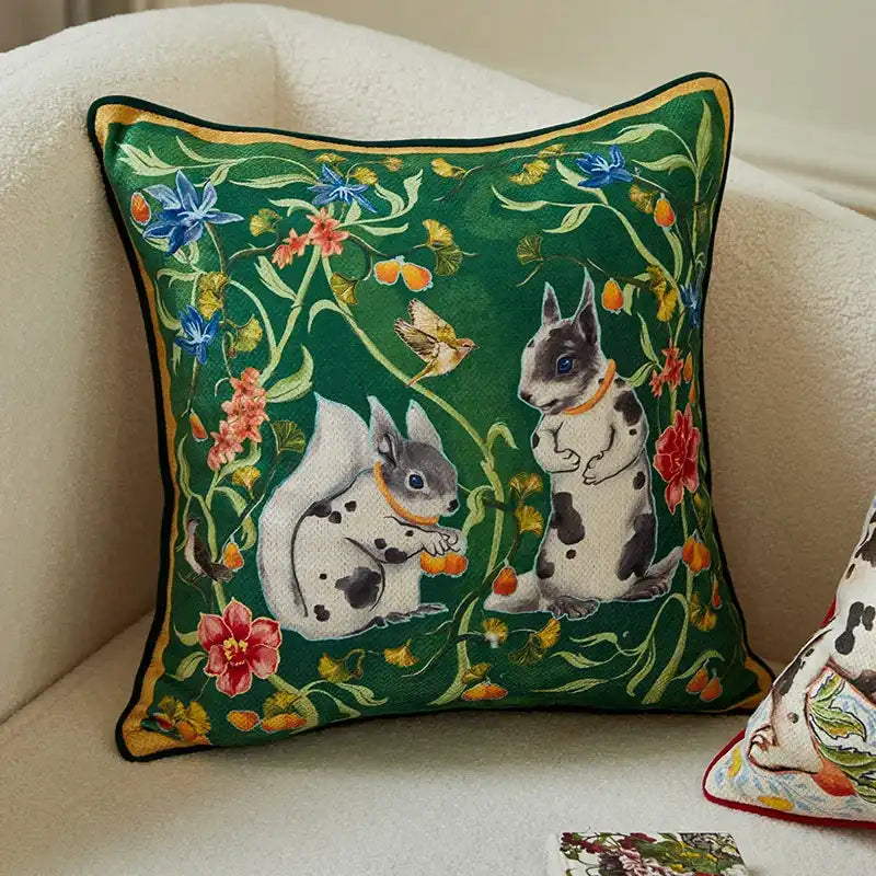Vintage squirrel motif throw pillow featuring playful squirrels surrounded by vibrant flowers and greenery.