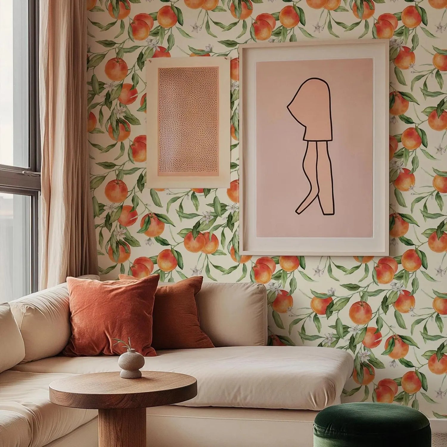 Living room with floral peach wallpaper, framed art, and a sofa.