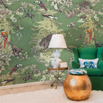 Living room with jungle-themed wallpaper, green sofa, and decorative items.