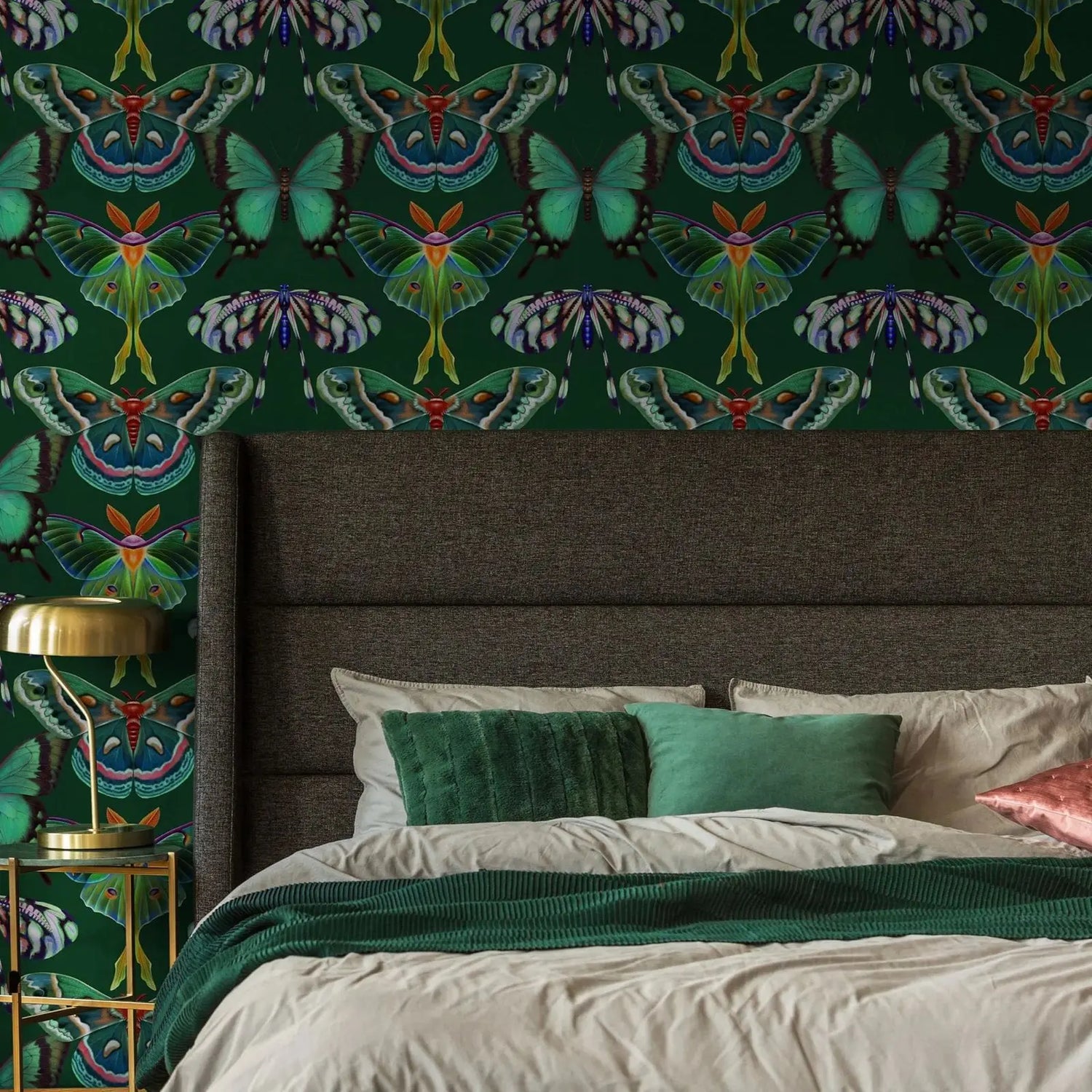 Bedroom with butterfly patterned wallpaper and a bed with green and beige bedding.