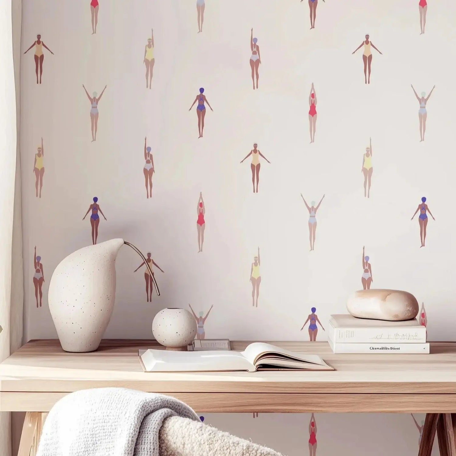 Wallpaper with small figures pattern on a wall above a wooden desk with decorative items.