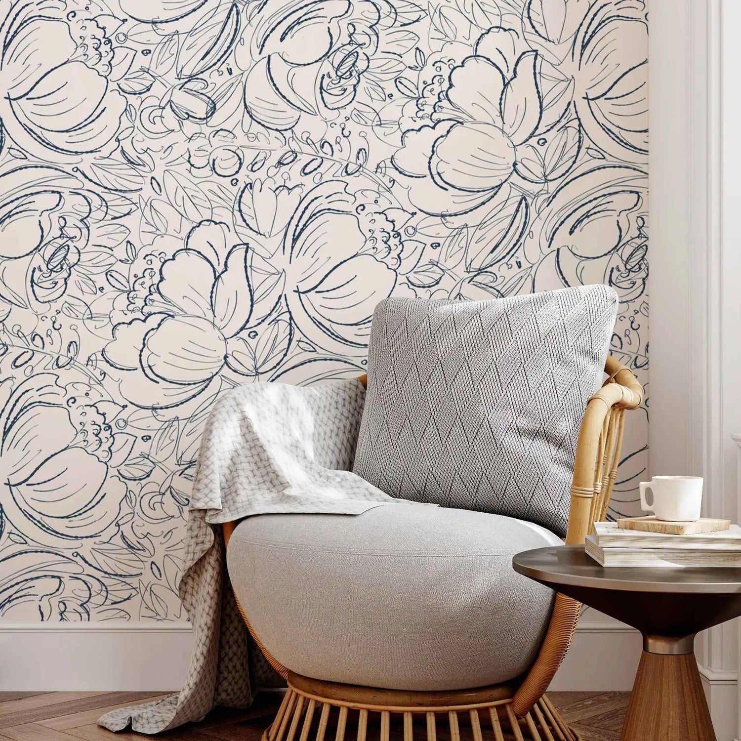 Cozy corner with a chair, pillow, and small table against a floral wallpapered wall.