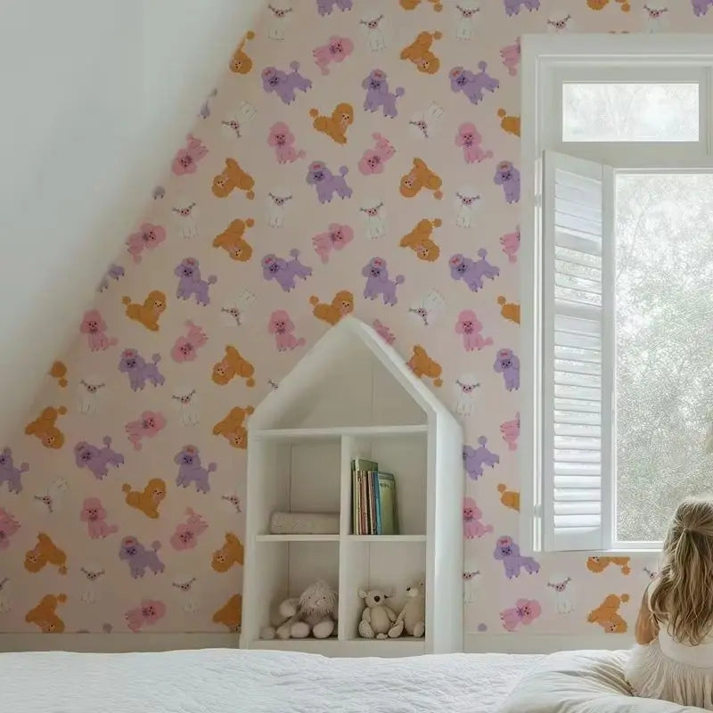Children's room with colorful wallpaper featuring cartoon dogs and a white bookshelf.