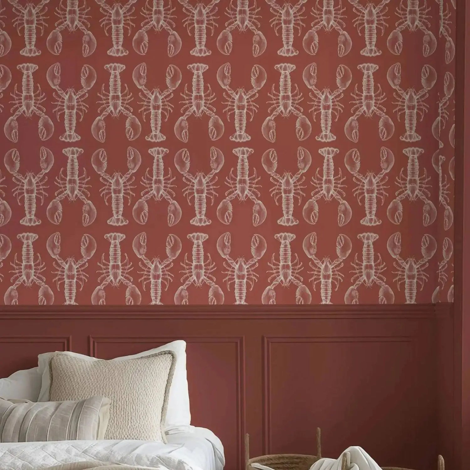 Wallpaper with lobster pattern on a red wall with a white sofa and pillows.