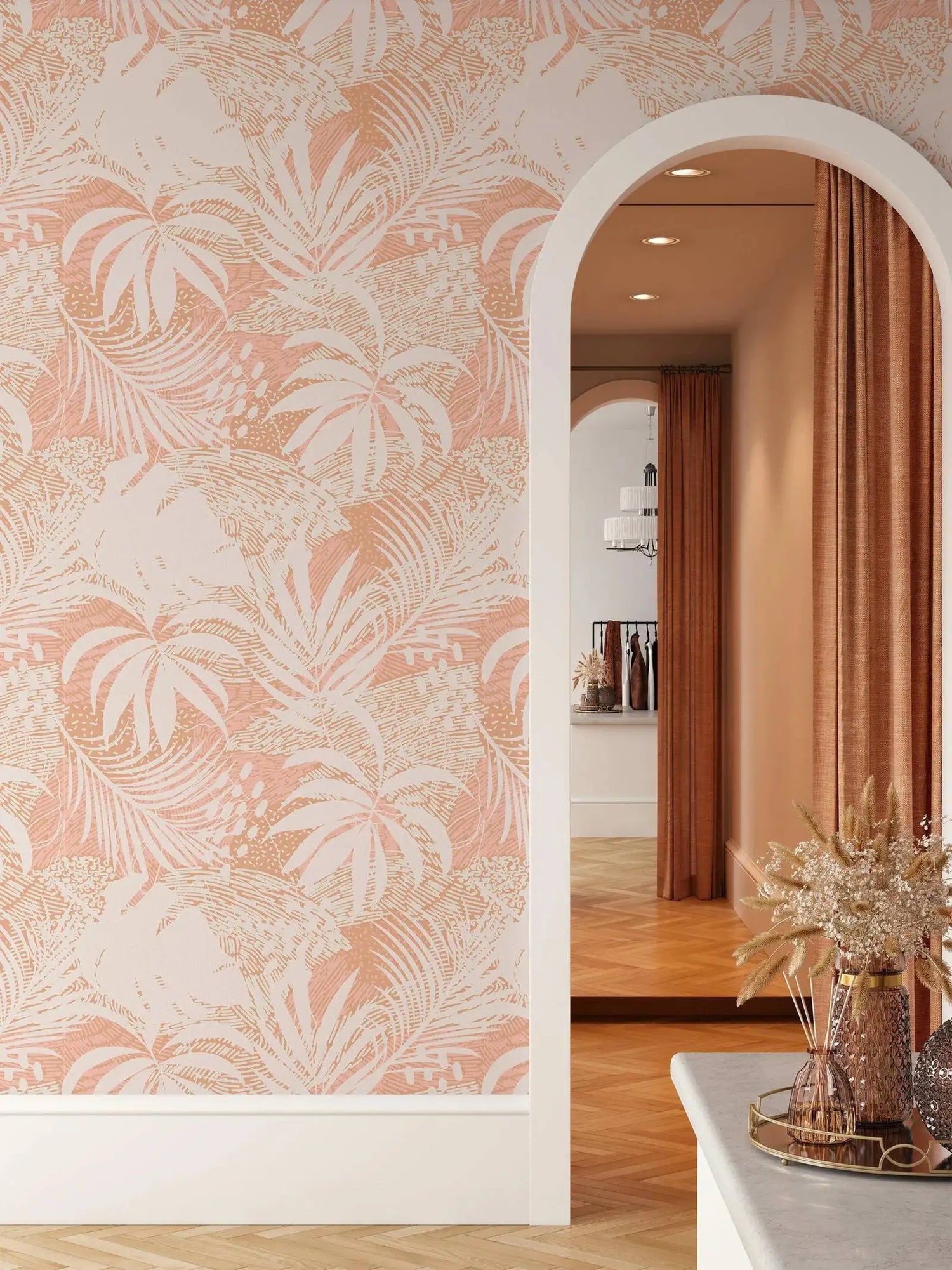 Room interior with pink and white floral wallpaper and a decorative mirror.