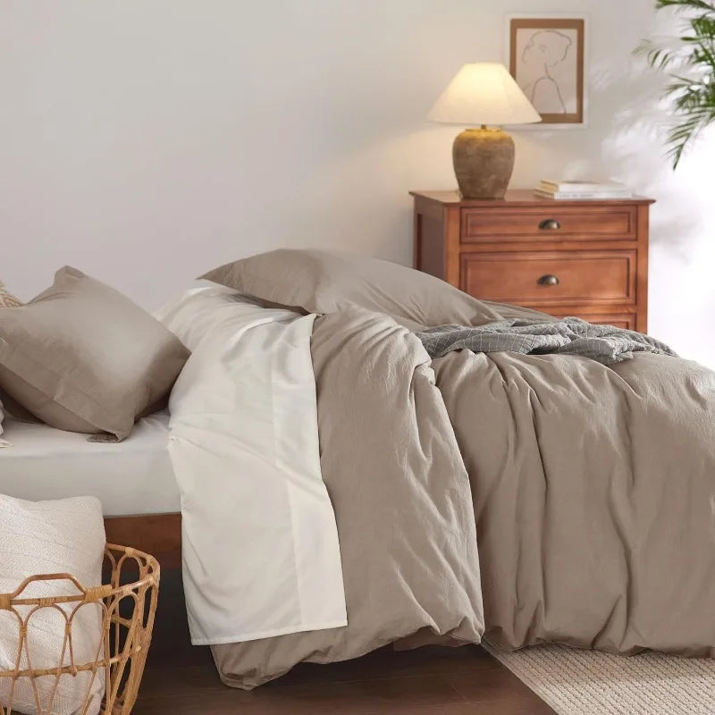 Washed Cotton Duvet Cover Set in Stone offers a blend of comfort and style, featuring a soft, relaxed texture achieved through stone-washing techniques. This process enhances the fabric's softness and imparts a lived-in look, making it a cozy addition to any bedroom.