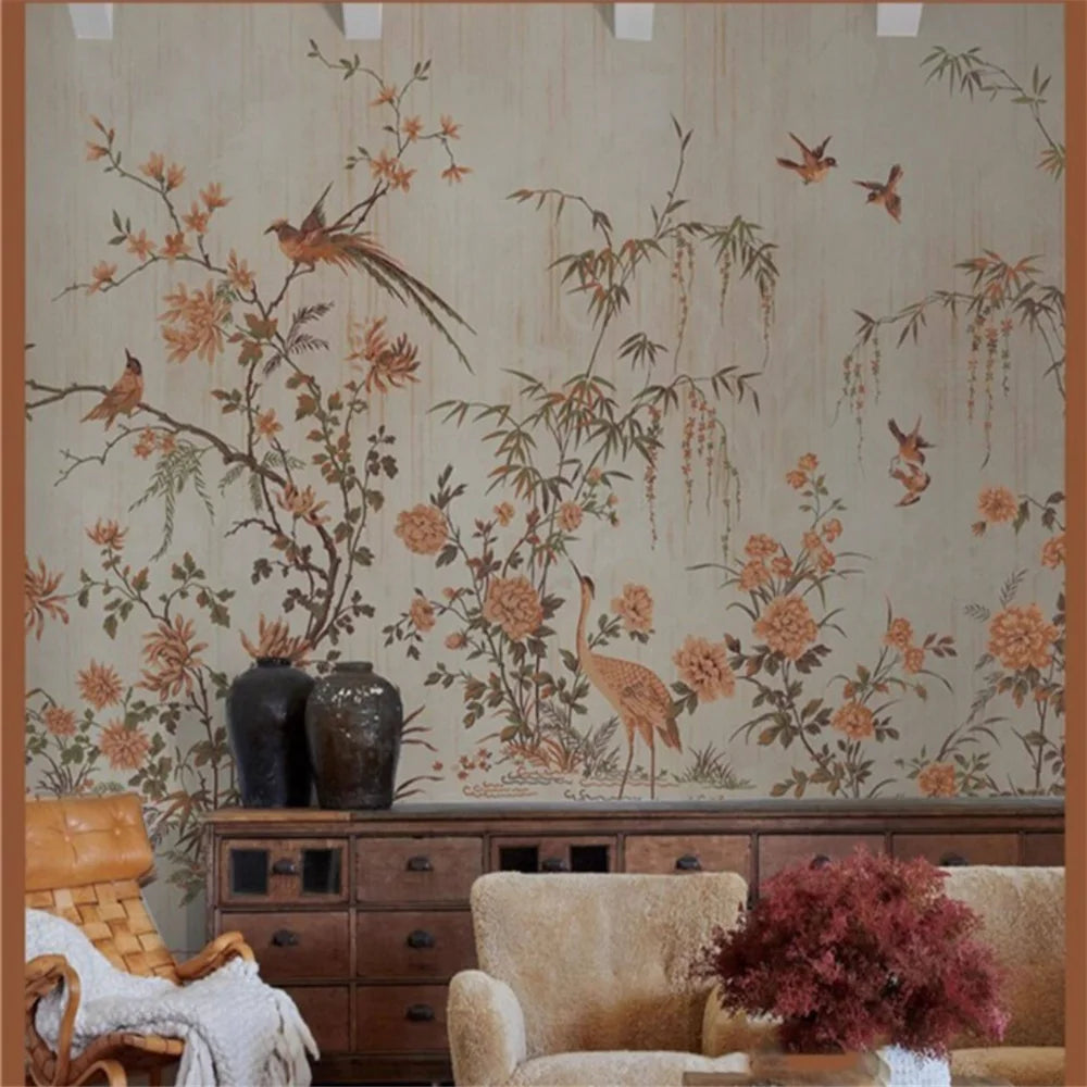 Living room with floral wallpaper featuring birds and plants, a wooden cabinet, and armchair.