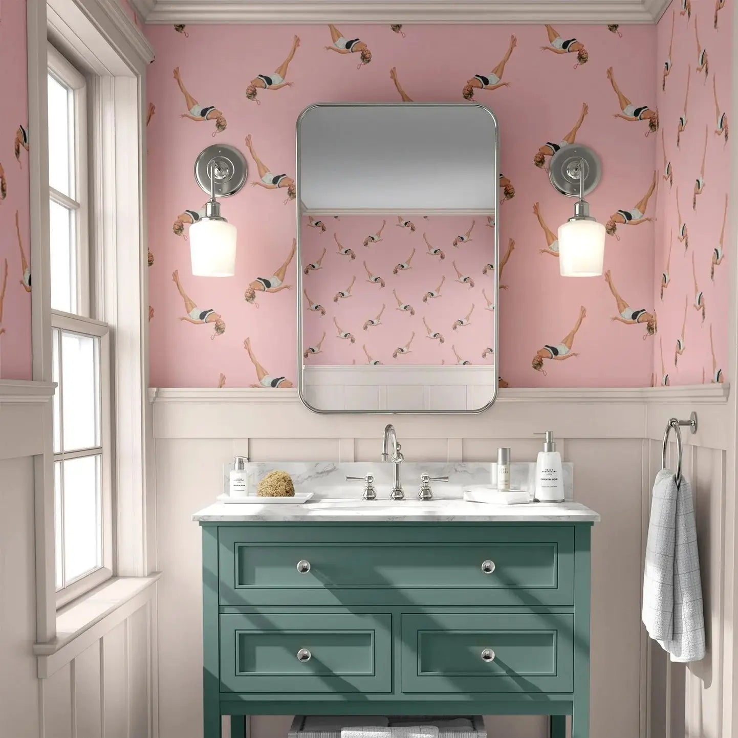 Bathroom with pink wallpaper featuring people in swimsuits, a green vanity, and a mirror.