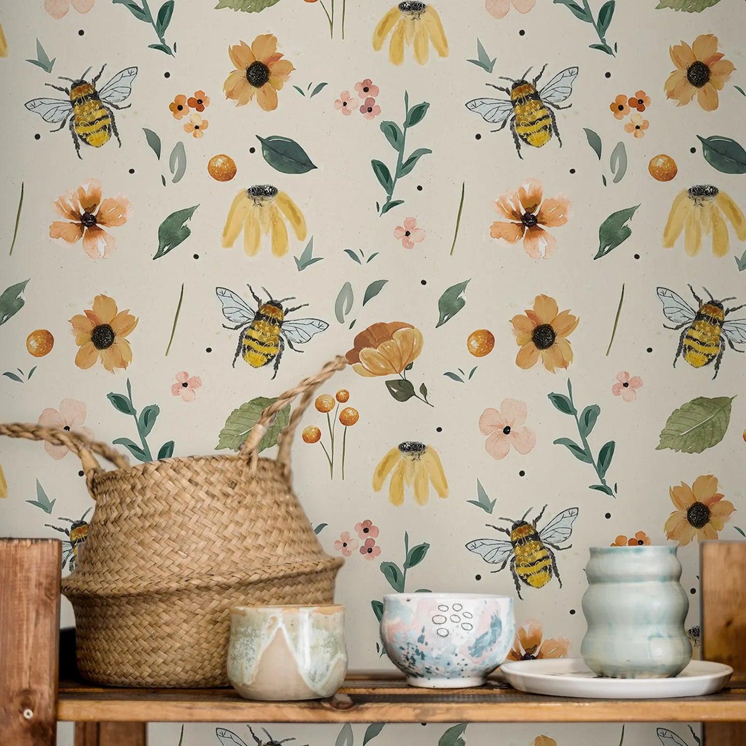 Wallpaper with bees and flowers, with a wooden shelf and decorative items below.
