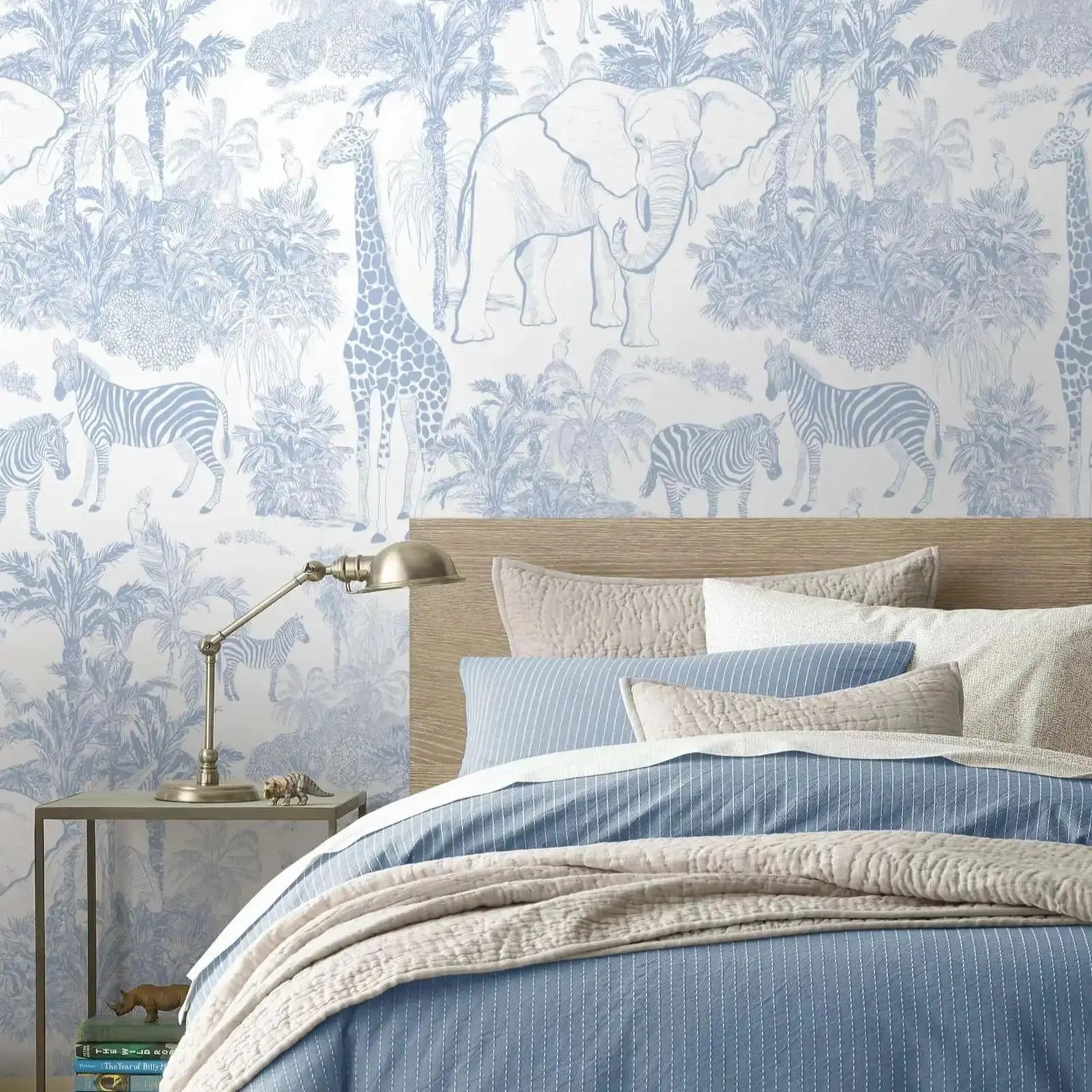 Bedroom with animal-themed wallpaper featuring elephants, giraffes, and zebras.