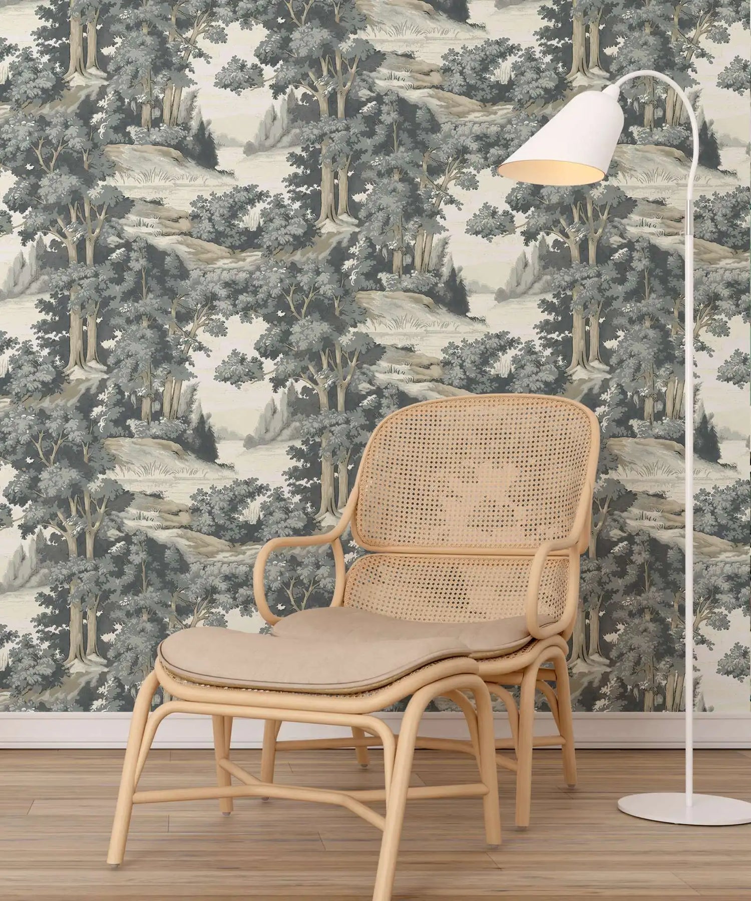 Wicker chair with beige cushion in front of forest-themed wallpaper