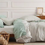 Washed Cotton Duvet Cover Set in Stone offers a blend of comfort and style, featuring a soft, relaxed texture achieved through stone-washing techniques. This process enhances the fabric's softness and imparts a lived-in look, making it a cozy addition to any bedroom.