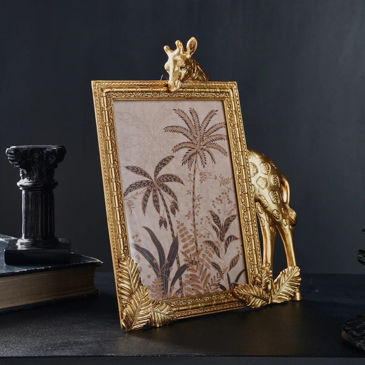 Decorative gold frame with a giraffe design on a dark background
