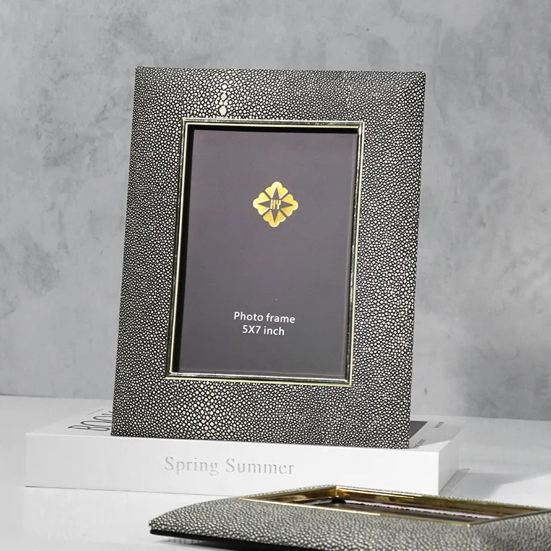 Silver photo frame with textured surface on a gray background
