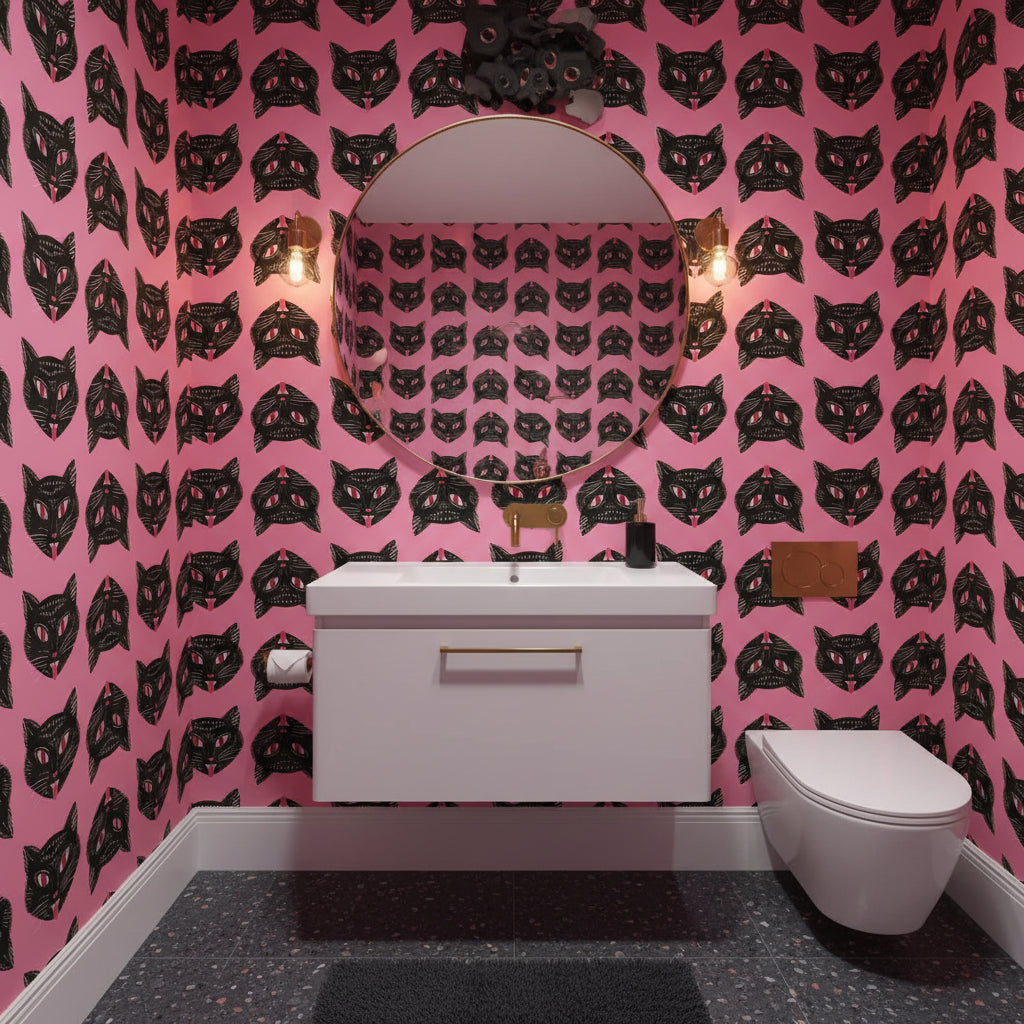 Living room with a red sofa, black coffee table, and pink walls with black cat pattern.