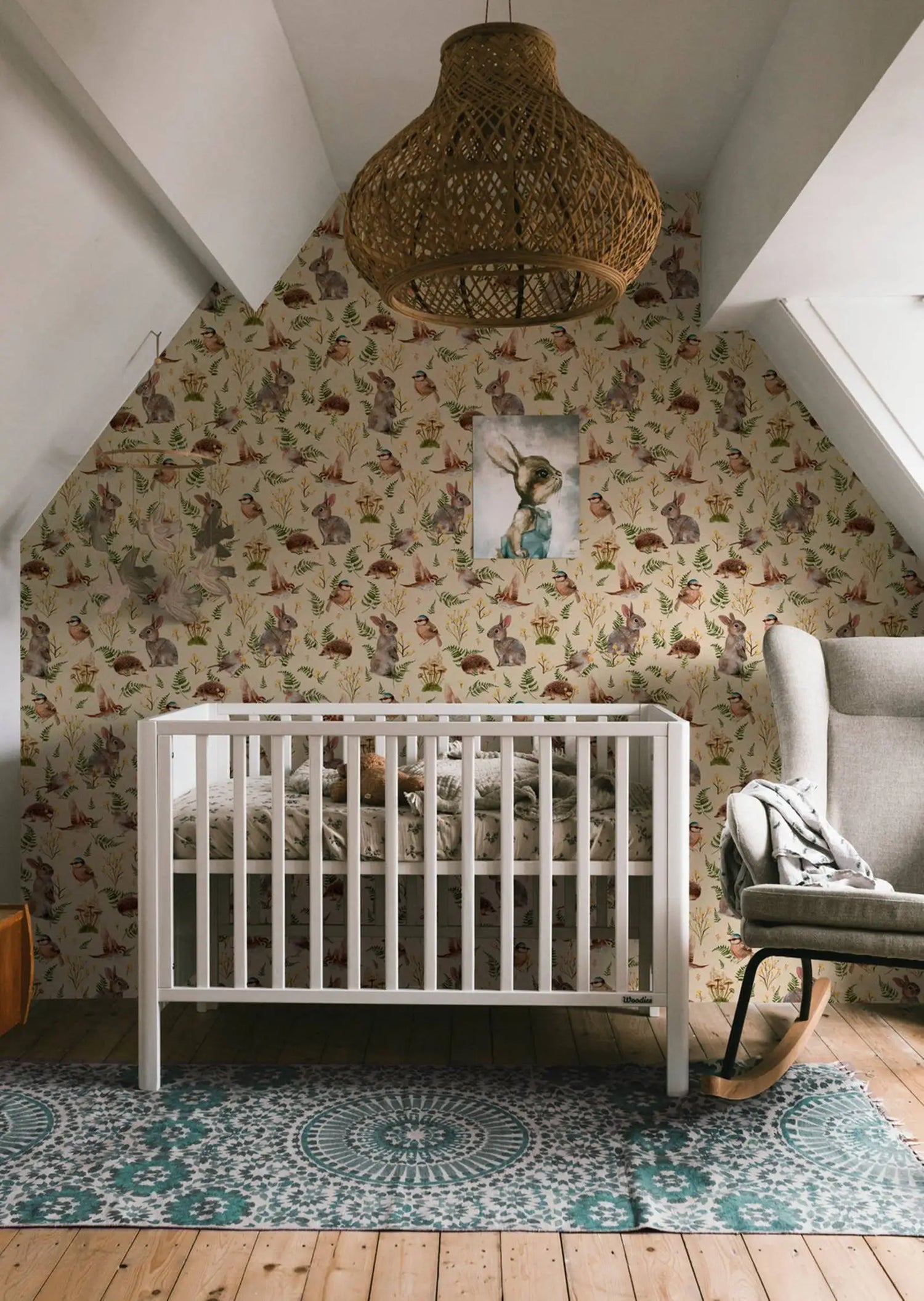 Nursery room with a crib, patterned wallpaper, and decorative rug.