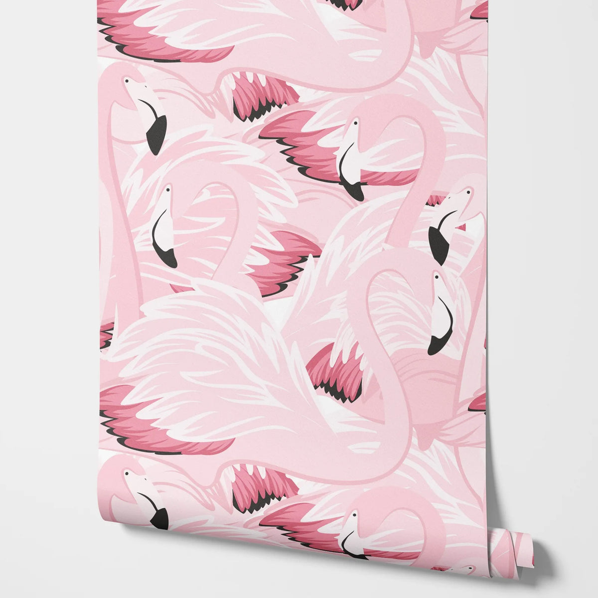 Roll of pink flamingo patterned paper on a white background