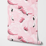 Roll of pink flamingo patterned paper on a white background