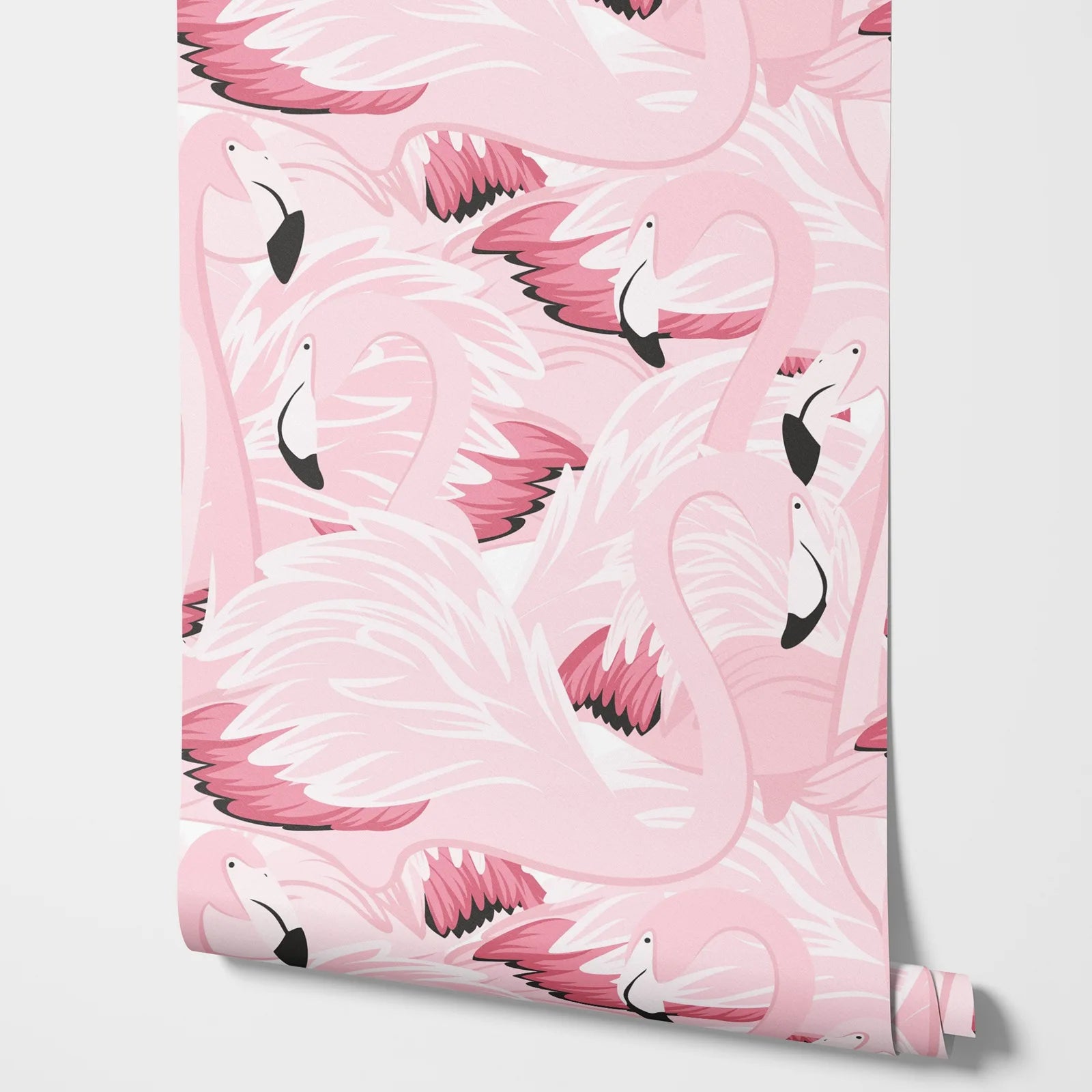 Roll of pink flamingo patterned paper on a white background