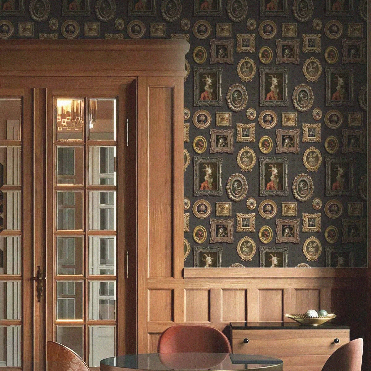 Dining room with wooden cabinets, a table, and chairs against a decorative wall with framed pictures.