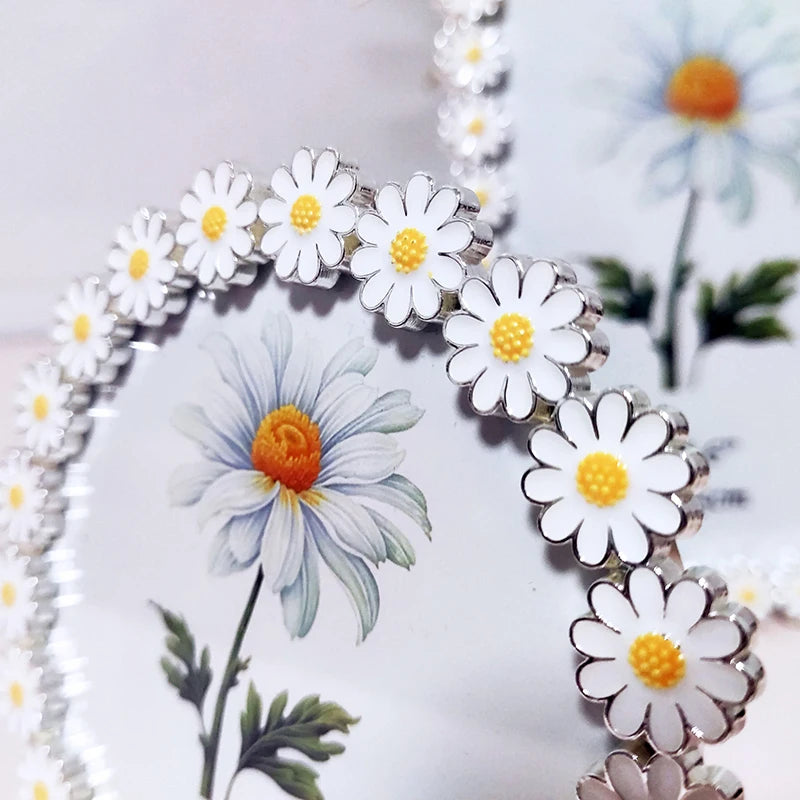 Daisy-shaped hair clips on a white background with floral elements.