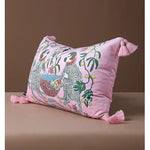 Retro monkey charm throw pillow with vibrant pink fabric and playful tassels, featuring whimsical monkey illustrations and botanical elements, perfect for adding a pop of color to any living space.