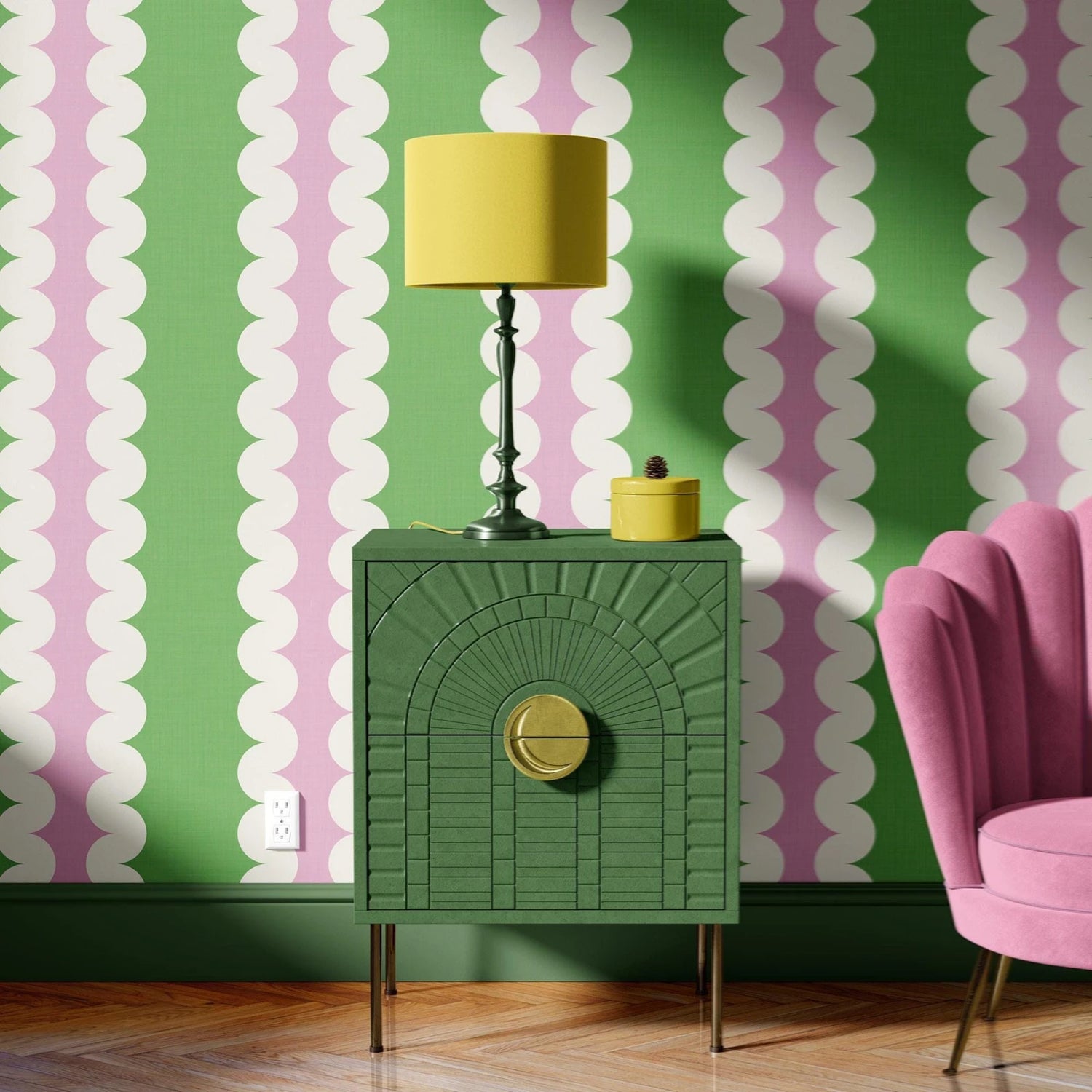 Green side table with yellow lamp against a pink and green striped wall