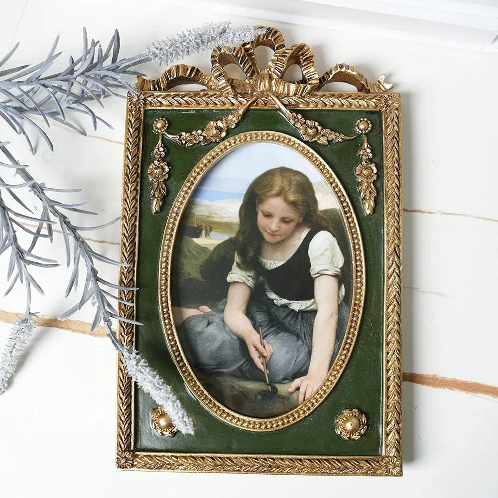 Decorative framed artwork of a young girl on a white surface with decorative elements.