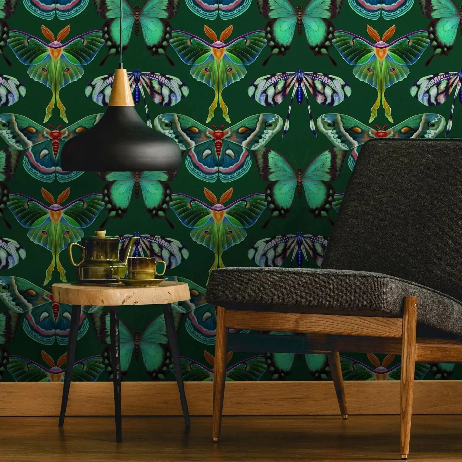 Room interior with a green butterfly-patterned wall, black chair, wooden table, and decorative items.
