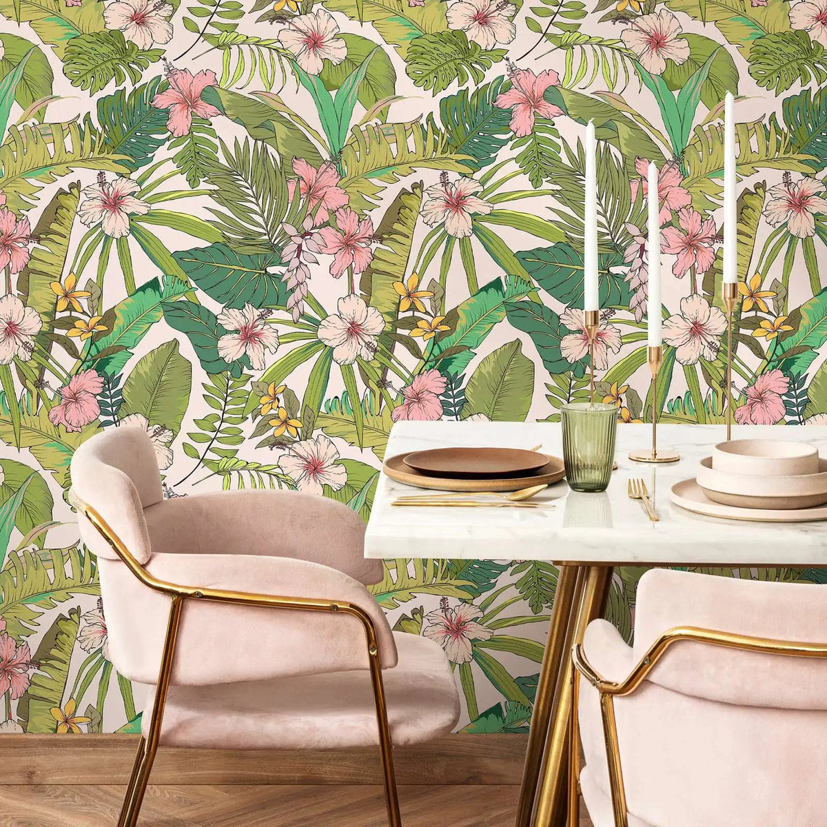 Dining table setting with pink chairs against a tropical leaf and floral wallpaper.