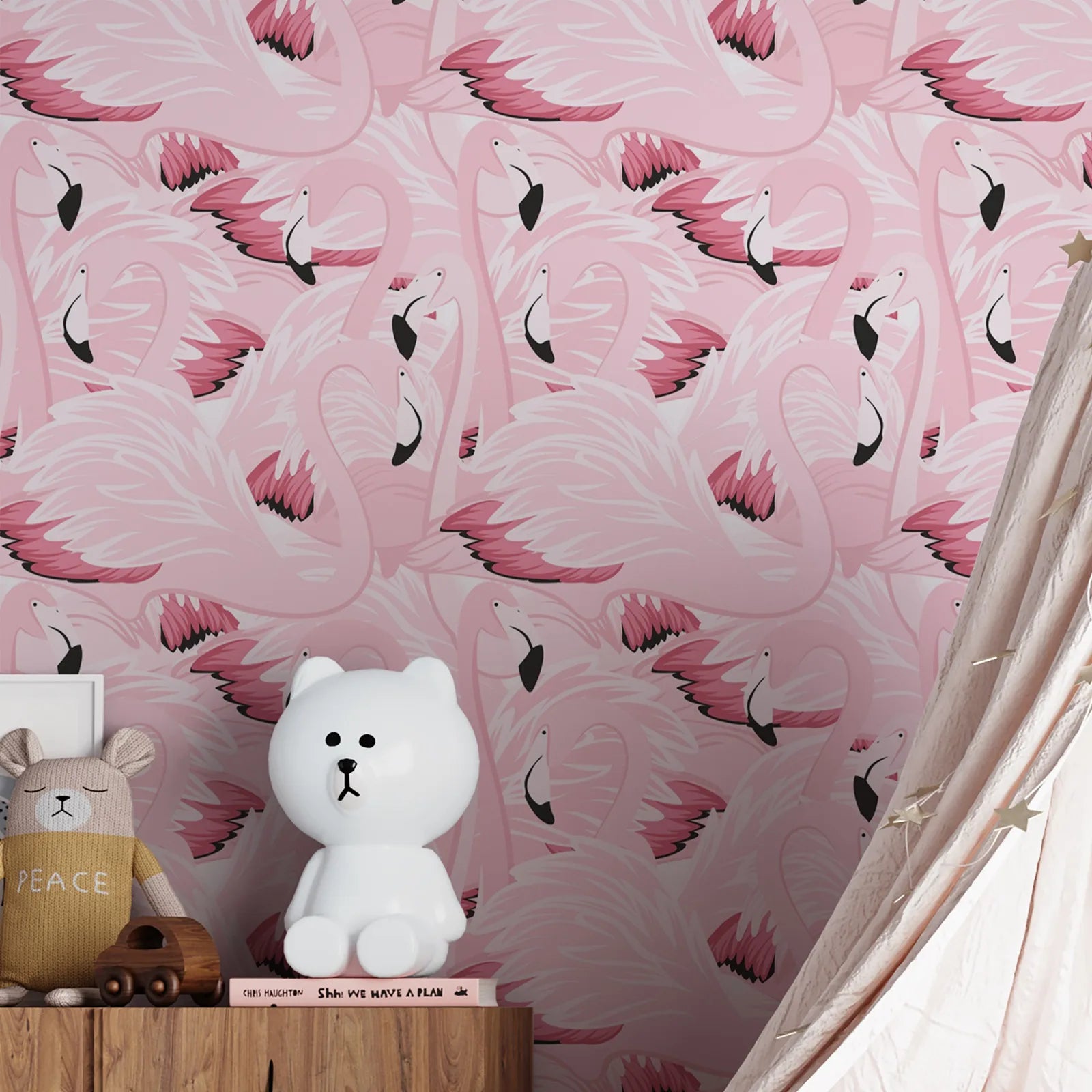 White teddy bear on a wooden shelf against a pink flamingo patterned wall.