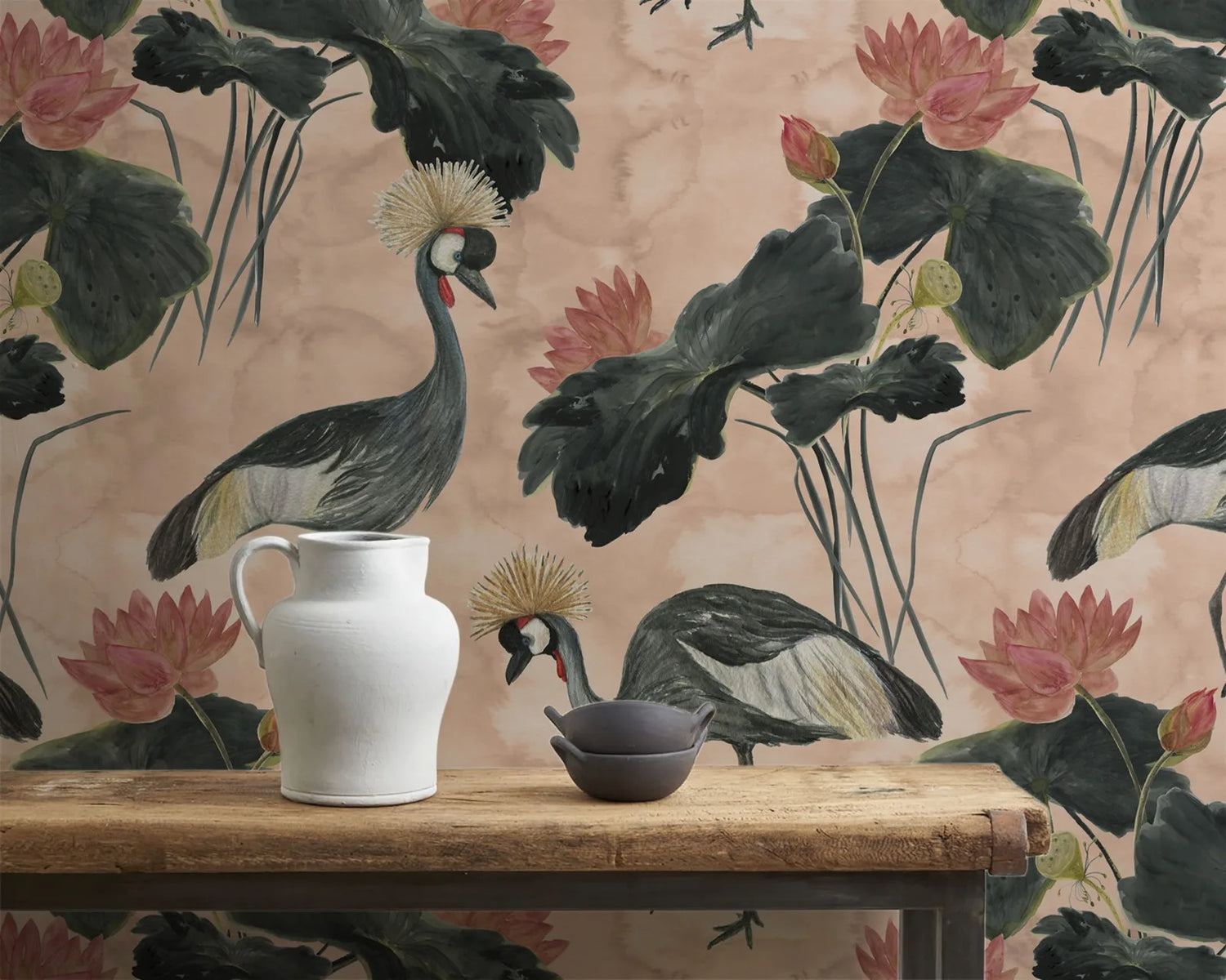 Decorative setting with a white vase, black bowl, and bird figurines against a floral wallpaper background.