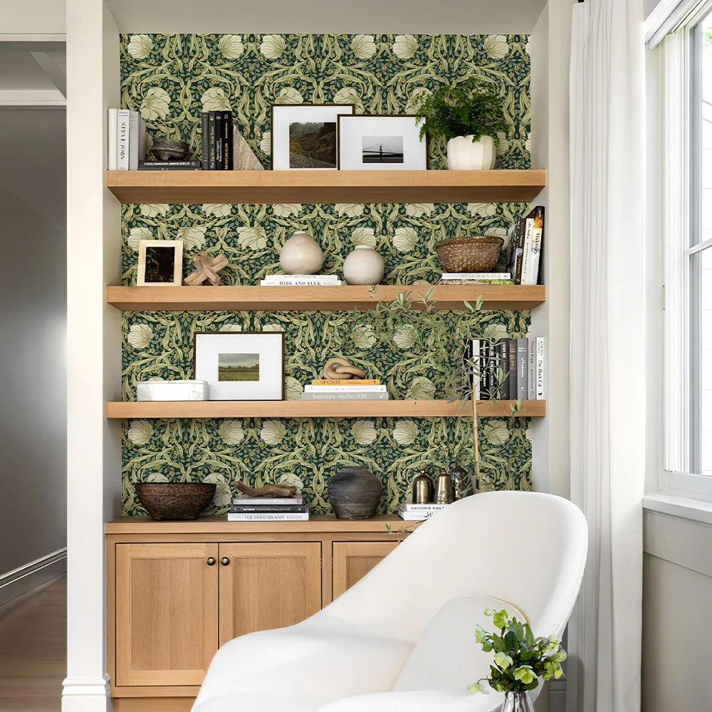 Shelving unit with decorative items against a patterned wall in a room.
