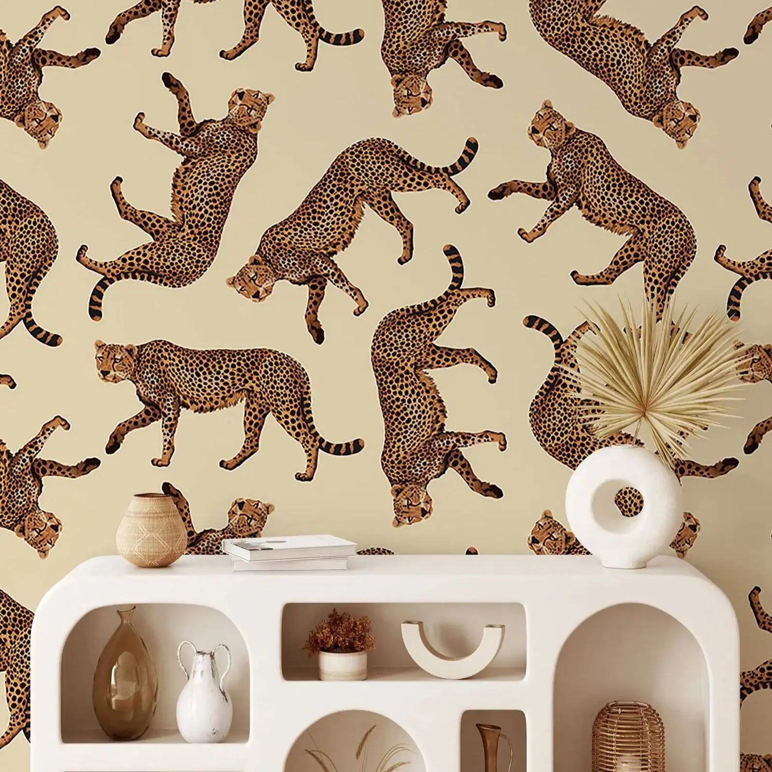 Decorative wall with cheetah pattern above a white console table with decorative items.