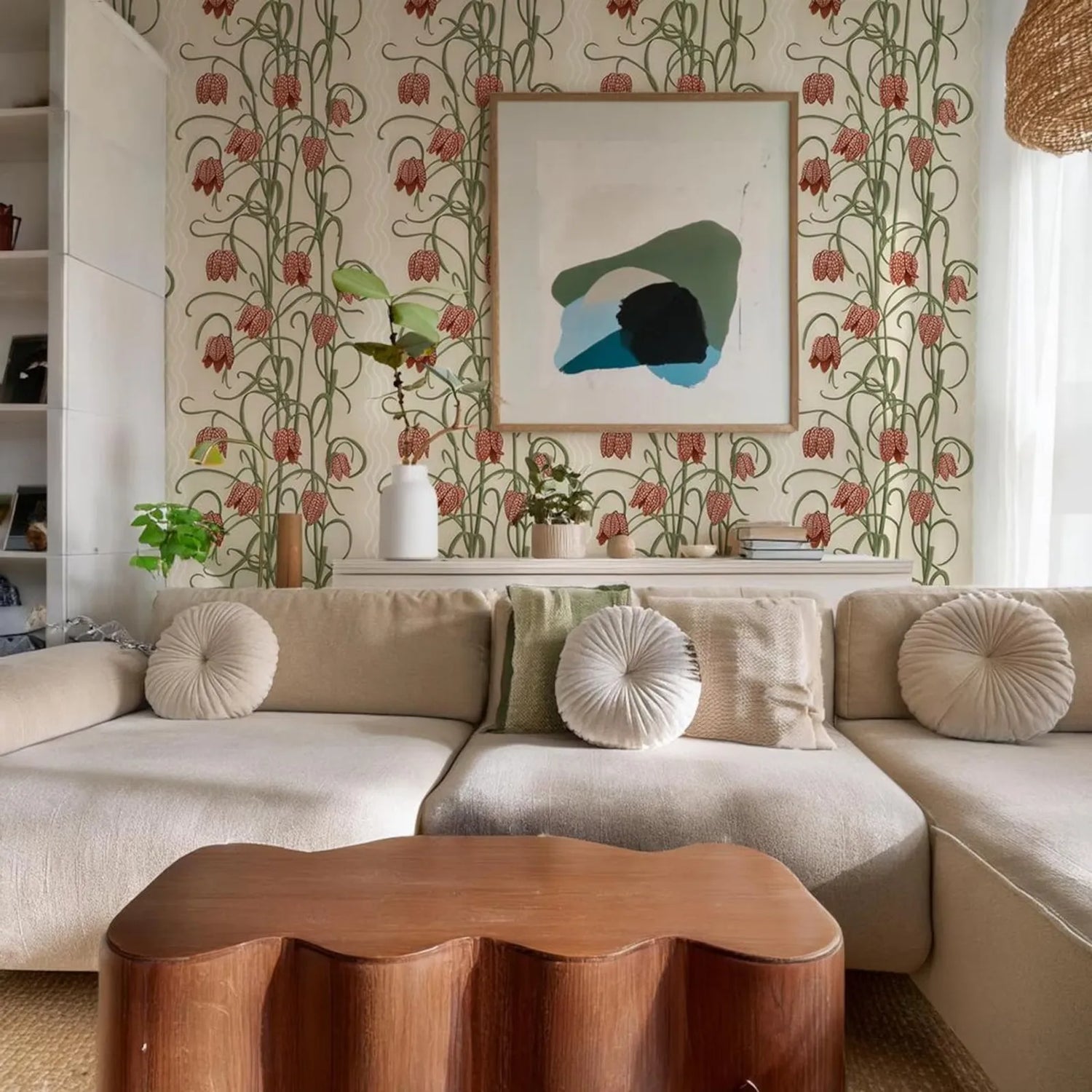 Living room with floral wallpaper, beige sofa, and wooden coffee table.