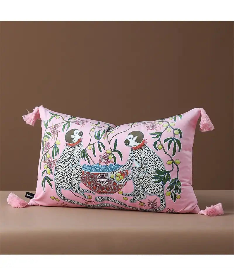 Retro monkey charm throw pillow featuring playful illustrations of monkeys surrounded by colorful foliage on a pink cushion cover, perfect for adding a whimsical touch to your home decor.
