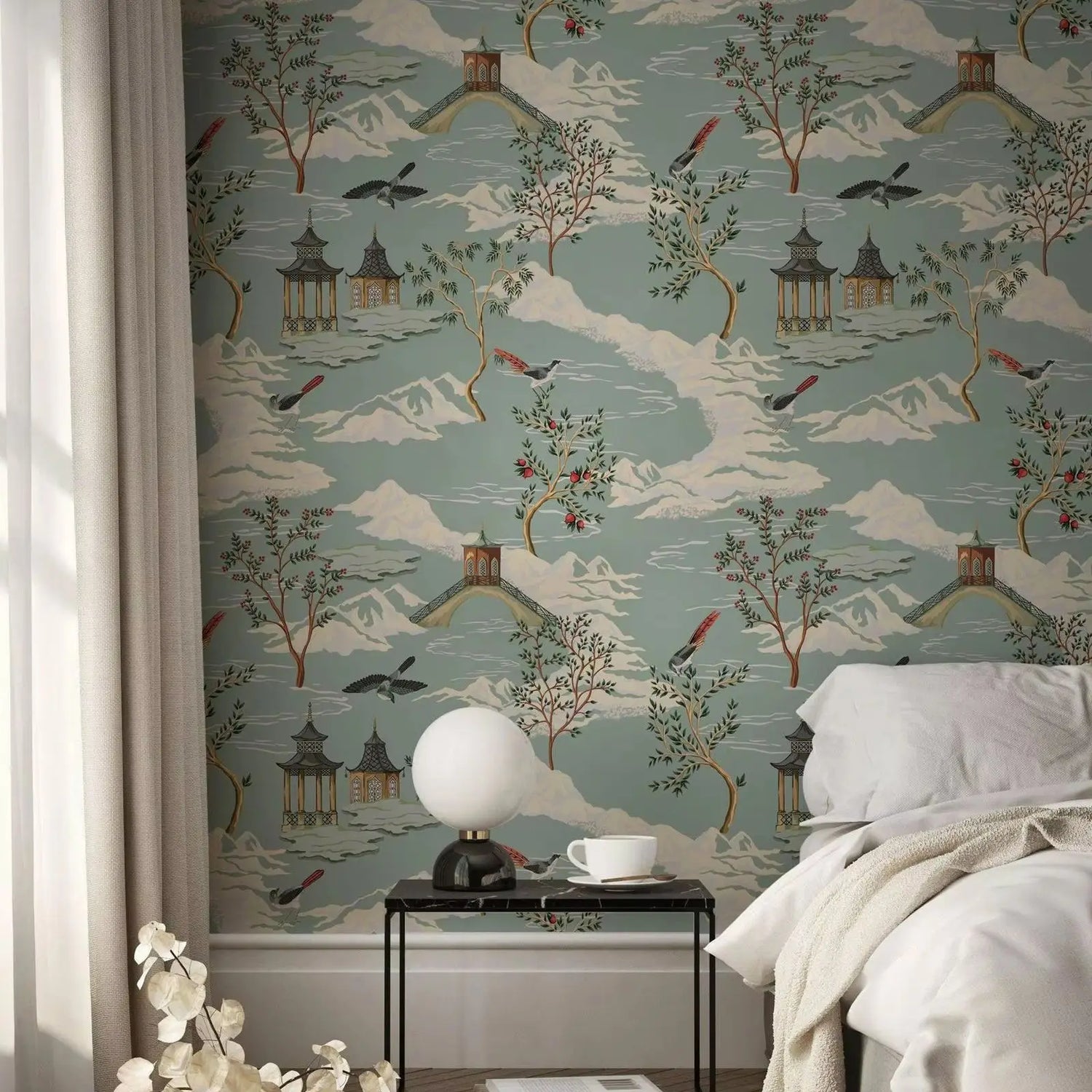 Room interior with decorative wallpaper featuring trees, pagodas, and birds on a blue background.
