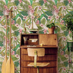 Wooden desk with chair against a tropical floral wallpaper background