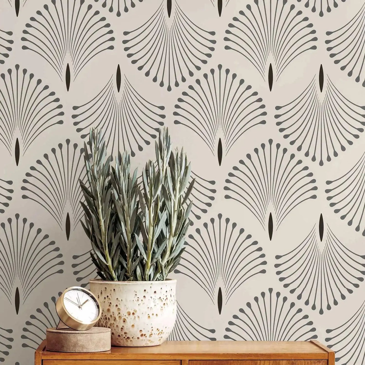 Decorative wallpaper with geometric pattern, plant, and clock on a wooden surface.