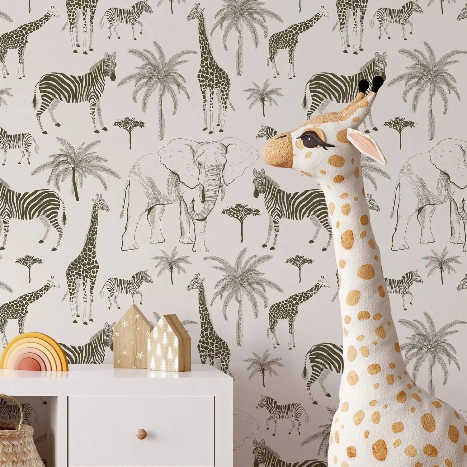 Plush giraffe toy in front of a wallpaper with animal patterns