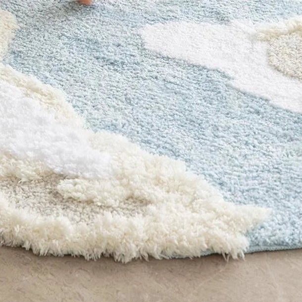Close-up of a textured rug with white and blue patterns on a neutral background