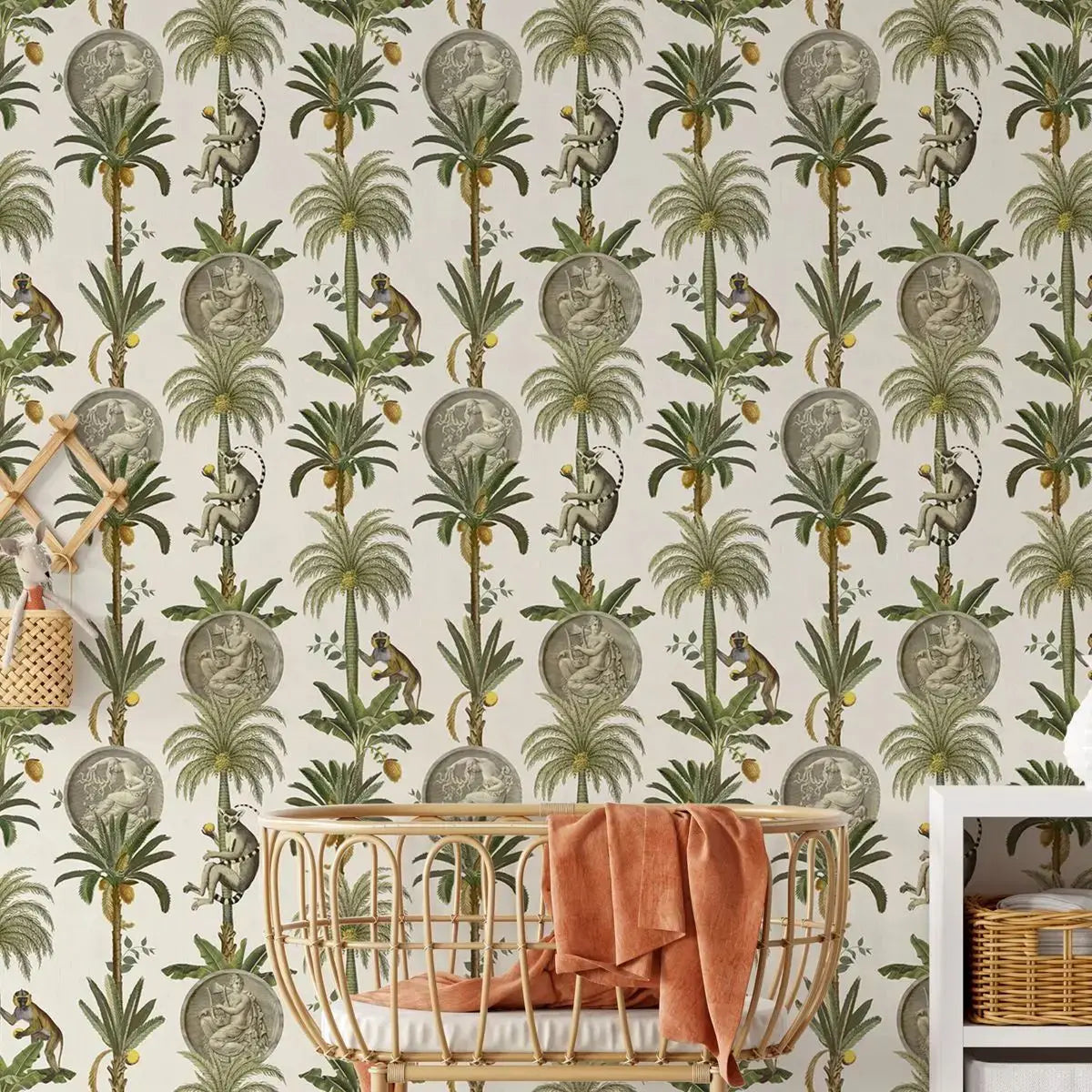 Wallpaper with tropical design featuring palm trees and monkeys, with a crib and basket in the foreground.