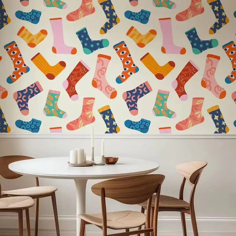 Dining room with a colorful sock pattern on the wall above a round table and chairs.