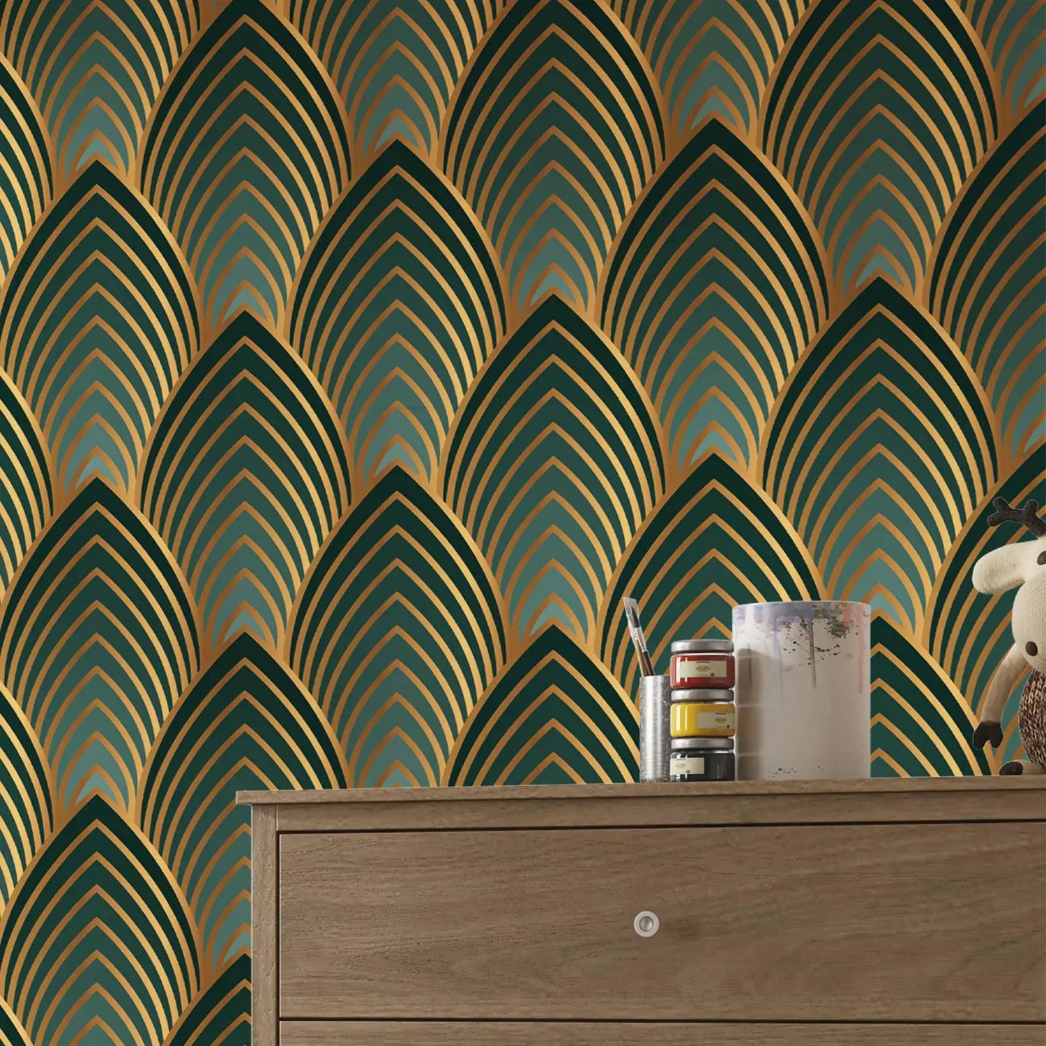 Wallpaper with geometric pattern in green and gold on a wooden surface.
