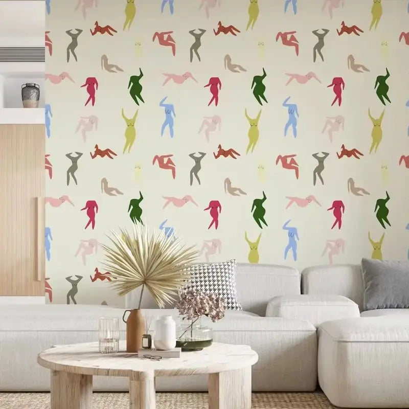 Living room with a wall featuring colorful abstract human figures and a white sofa.