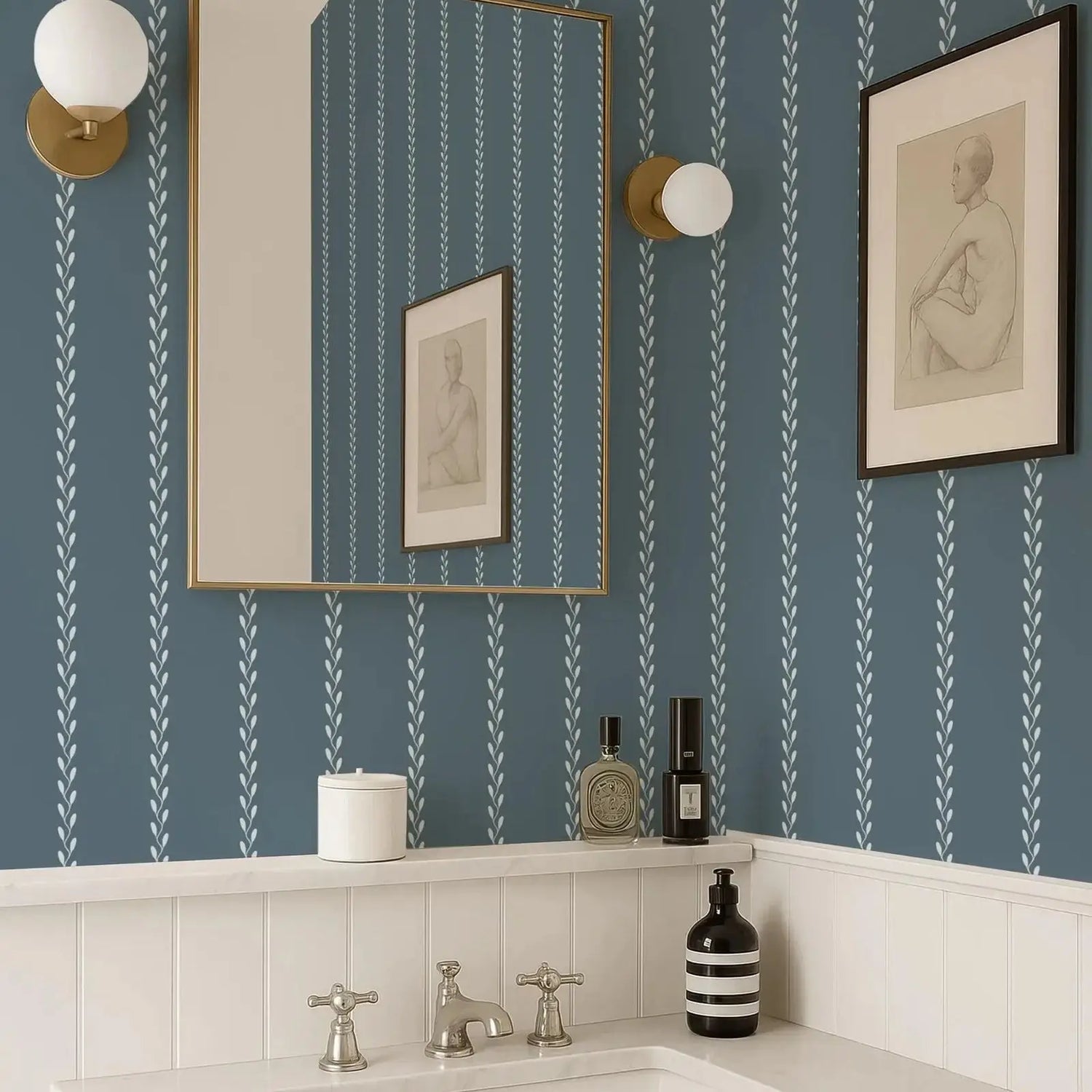 Bathroom with blue striped wallpaper, mirror, and decorative items.